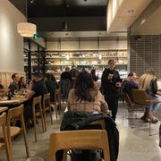 people sitting at tables in a restaurant
