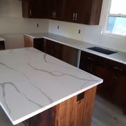 New Calcutta Quartz Counters with a Carrera Quartz Backsplash