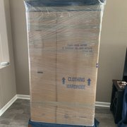 A glass piece of furniture wrapped with extra protection.