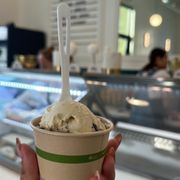 a hand holding a cup of ice cream