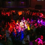 a crowd of people dancing at a party