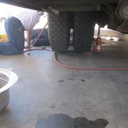 This isn't *just* a flat tire, it seems -- and not afraid to get their white shirts dirty.