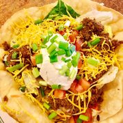 Our delicious Taco Salad topped with sour cream and green onions! Ask for one of our homemade salsas!