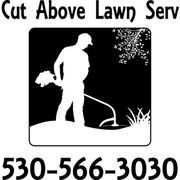 a silhouette of a man mowing a lawn