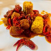 Seasonal crawfish, sausage, corn on the cob, and a cup of rice (with house sauce, medium spice).