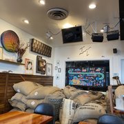 a coffee shop filled with bags of coffee