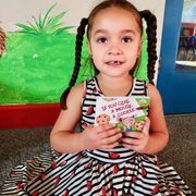 Look at that focus!! We love to see our kids reading books and being read too!
