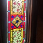 The stained glass window lights up the stairway