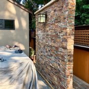 a patio with a stone wall