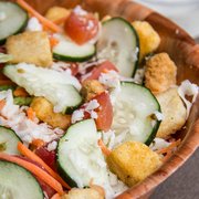 Brother Tom's Salad: Crisp romaine and spring lettuce, sliced carrots, cucumbers, fresh roma tomatoes, premium mozzarella cheese, croutons