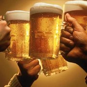 a group of people toasting with beer