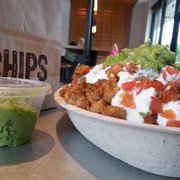 Burrito bowl with half of my tortilla chips underneath. The other half i used for my extra guacamole.