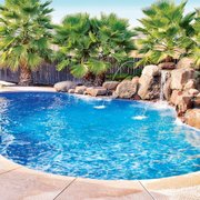 a pool surrounded by palm trees