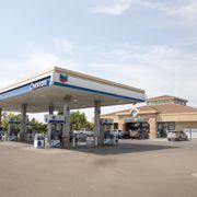 a gas station with cars parked in front of it