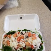 a salad in a styrofoam container