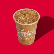 a cup of iced coffee on a red background