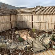 a small garden with a bridge