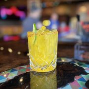 a close up of a yellow cocktail