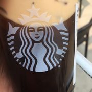 a hand holding a cup of coffee