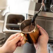 Steaming chocolate milk for a creamy hot cocoa soon to be topped with house made whipped cream!