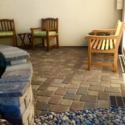 a patio with chairs and a fountain