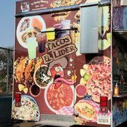 a taco truck parked in a parking lot