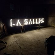 Custom Sign with LED Lighting and Patinated Steel Letters.