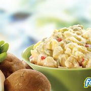 a bowl of potato salad and a roll