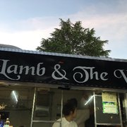 a man and a woman standing in front of a food truck