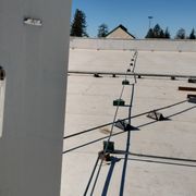Roof jacks and new conduit installed on roof in green