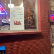 a neon sign in the window of a restaurant