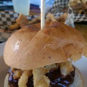 a burger with onion rings
