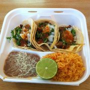 Carnitas tacos with rice and beans.