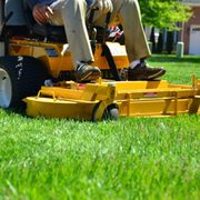 a man sitting on a lawn mower